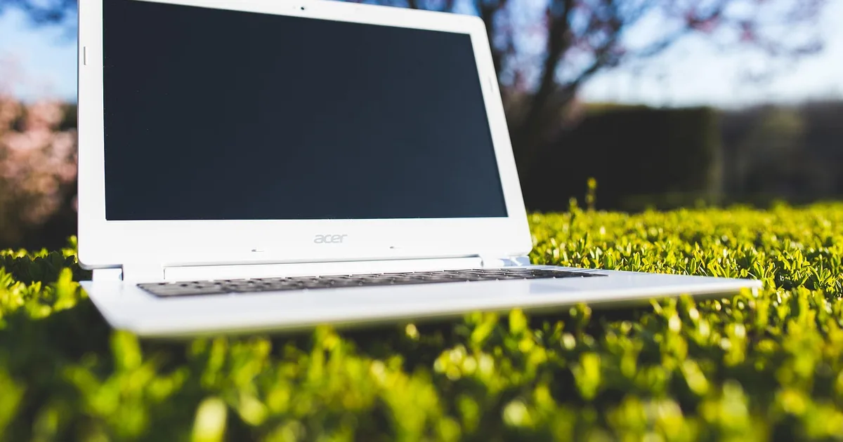Laptop keyboard and screen beside a screen reader setup used for accessibility testing