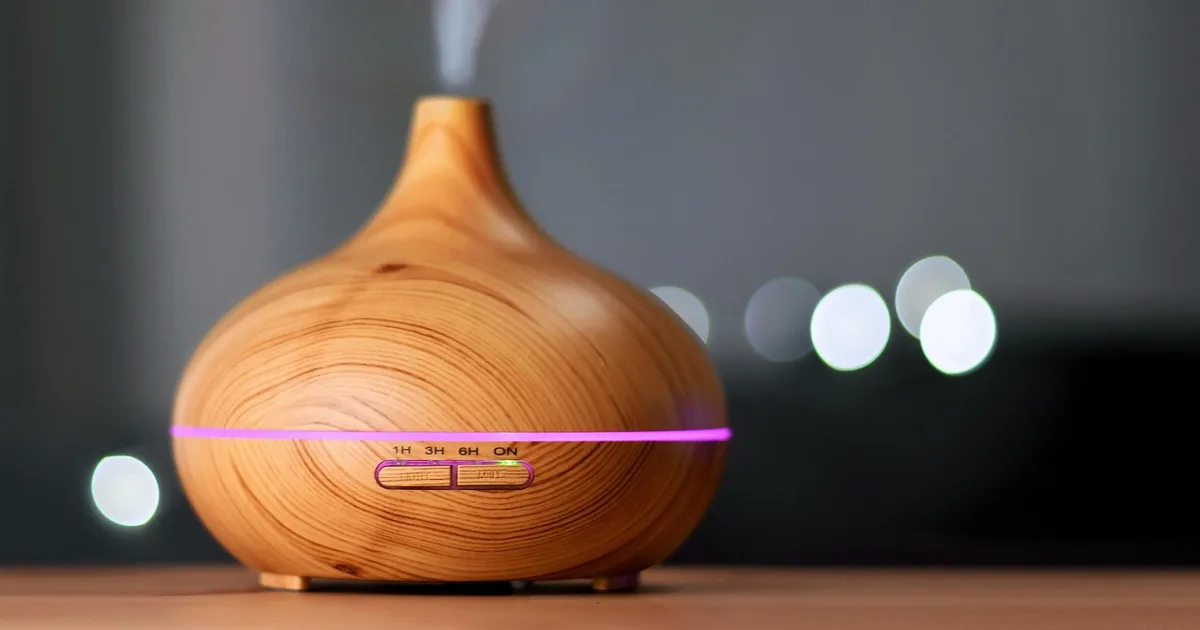 An ultrasonic humidifier releasing white mist in a living room