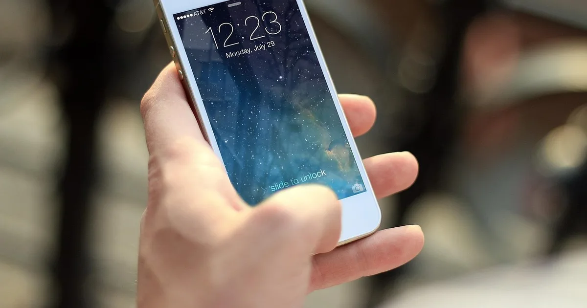 Person holding a smartphone to send a mobile payment