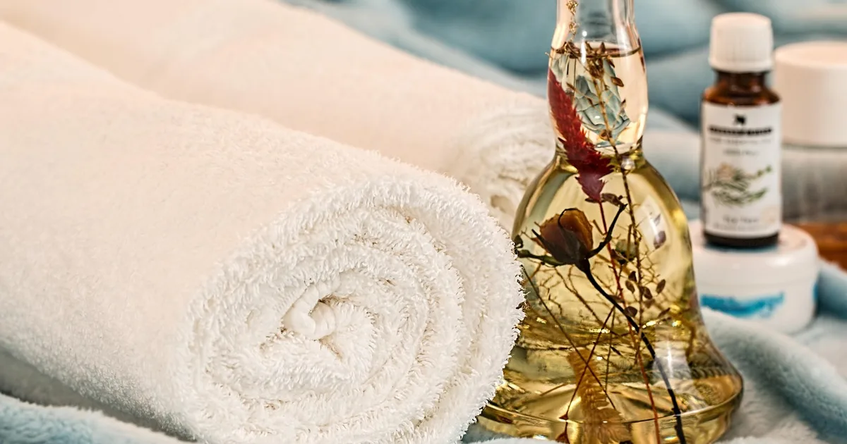 Treatment room in a medical spa with folded white towels on a table