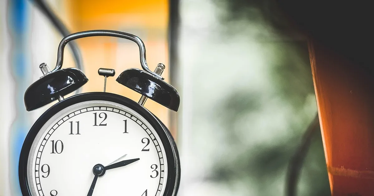Time clock hanging on a wall in a factory where hourly workers punch in