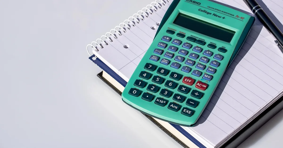 A calculator and a tax form on a desk