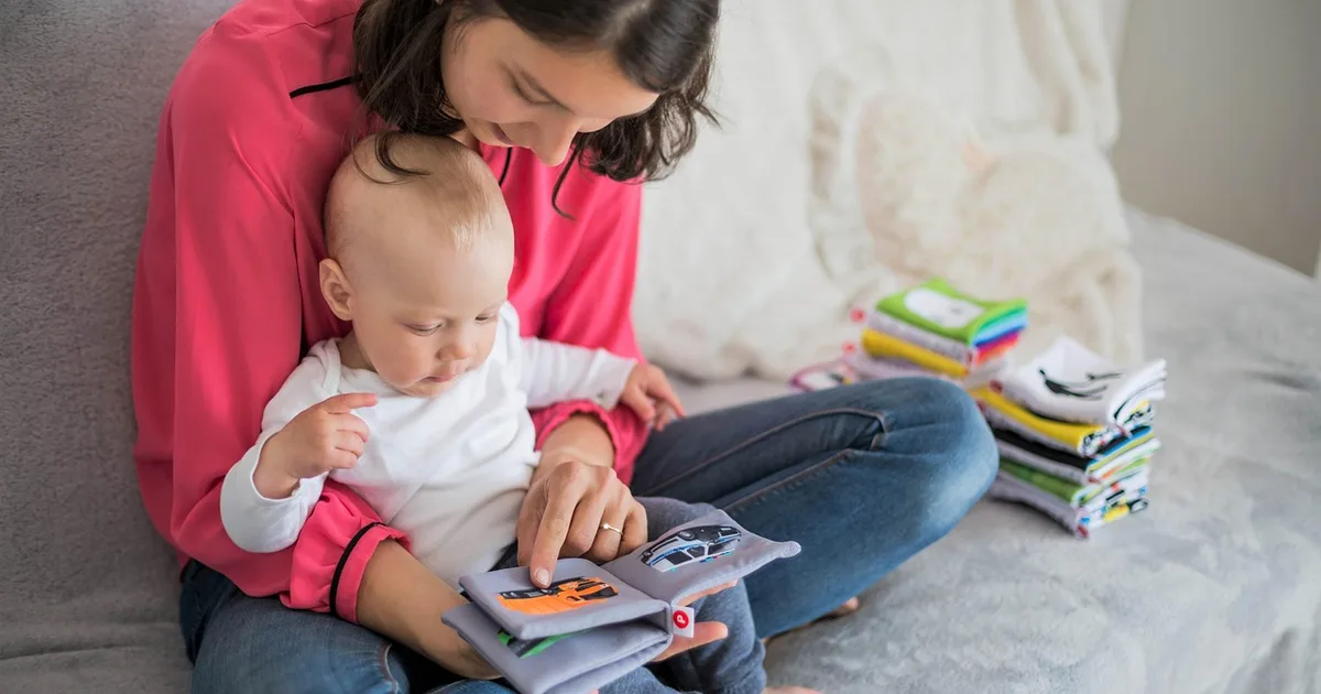 A family watching a tablet together on a sofa